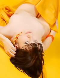 Beautiful and attractive brunette gal Abu A takes her orange dress off and shows off her body.