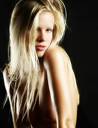 Lusty blonde model Marketa B takes her clothes off and shows off her big juicy breasts.
