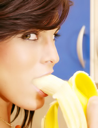 Beautiful brunette babe Nella A eats some fruit in the kitchen without any clothes on.