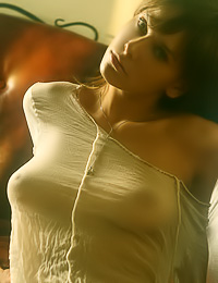 Busty teen model Julia O takes off her white underwear on the bed and shows her massive jugs.